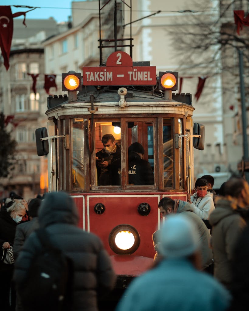 Red Retro Tram Surrounded with Crowded People